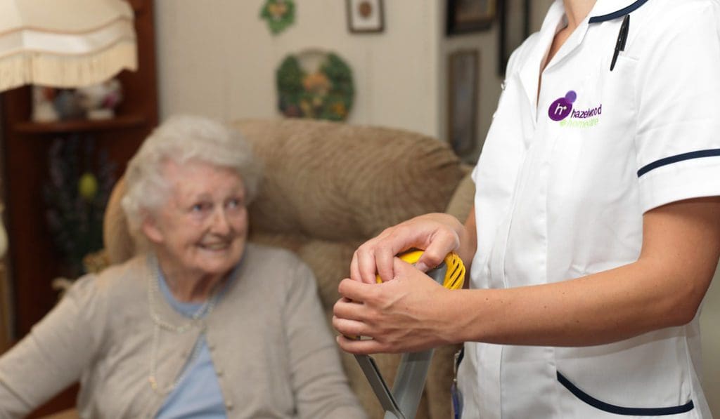 An image of a care worker in uniform and an elderly lady. Homecare services