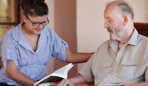 A support worker reading a notebook with a service user