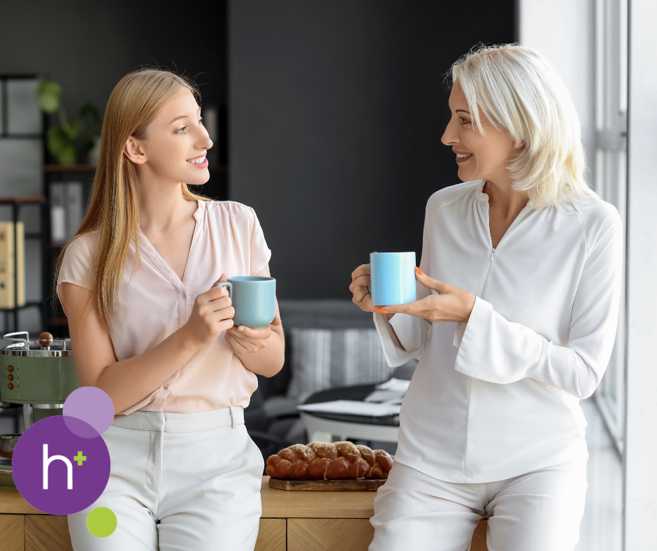 A photograph of two women having a cup of tea together